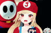 a girl is wearing a red hat with a letter j on it