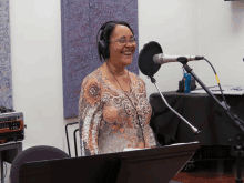 a woman is singing into a microphone in front of a wall that says west central quartet on it