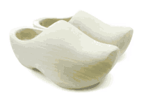 a pair of white wooden clogs on a white surface