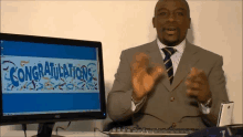 a man sitting in front of an aoc computer monitor