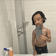 a man taking a picture of himself in a bathroom