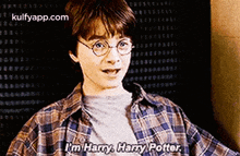 harry potter is wearing glasses and a plaid shirt and talking to someone .