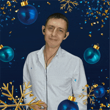 a man in a white shirt is surrounded by blue and gold christmas ornaments and confetti