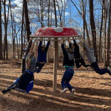 a group of kids are playing on a mushroom shaped playground