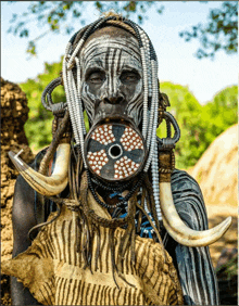 a man with a large lip ring and horns on his face