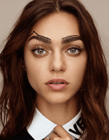 a close up of a woman 's face with her eyebrows drawn