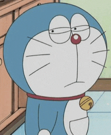 doraemon is a cartoon cat with a bell around his neck and a sad look on his face .