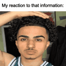 a young man with curly hair holds his hand to his head with the caption my reaction to that information