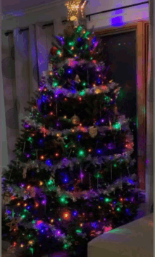 a christmas tree is decorated with lots of lights and decorations