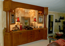 a living room with wooden cabinets and lamps