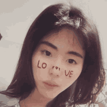 a woman with the word love written on her face