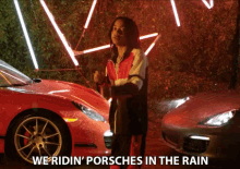 a man is standing in front of a red porsche with the words we ridin ' porsches in the rain below him