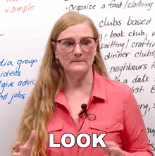 a woman wearing glasses stands in front of a white board that says " organize a food / clothing " on it