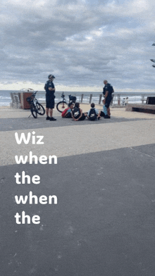 a group of people sitting on the sidewalk with the words " wiz when the when the " on the bottom