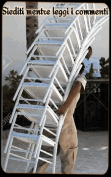 a man is carrying a stack of chairs with the caption " siediti mentre leggi i commenti " above him