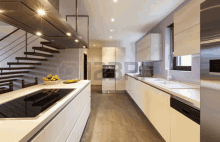 a modern kitchen with stainless steel appliances and stairs