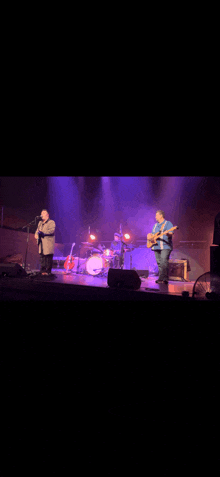 a group of men are playing instruments on a stage .