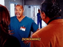 a man in scrubs is screaming while talking to another man