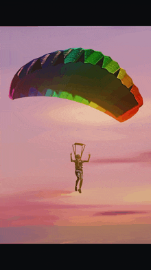 a man is flying through the air with a rainbow parachute