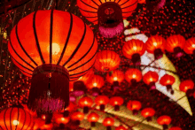 a bunch of red lanterns hanging from the ceiling