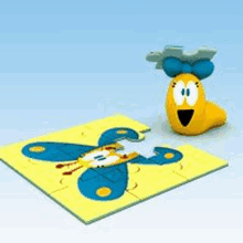 a puzzle with a butterfly on it and a yellow worm