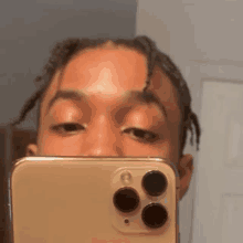 a man is taking a picture of himself in a mirror with his phone .