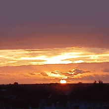 a sunset with a few clouds in it