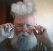 a man with glasses and a beard looks at the camera with a cloud coming out of his head