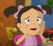 a cartoon girl with a pink bow in her hair is holding her face with her hands .