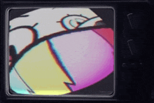 a tv screen shows a cartoon character with a purple and yellow face