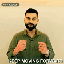 a man with a beard is giving a thumbs up sign while wearing a green shirt and a watch .