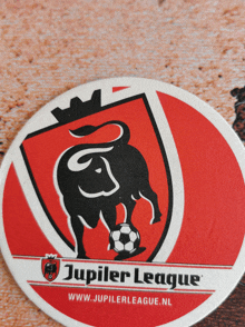 a jupiler league coaster with a bull and soccer ball on it