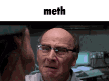 a bald man wearing glasses is making a funny face with the word meth below him