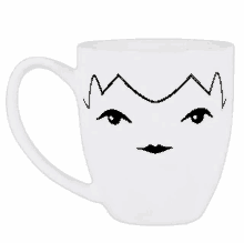 a white mug with a face drawn on it