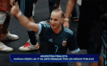 a man wearing a jersey with the number 7 on it stands in front of a sign that says argentina finalista