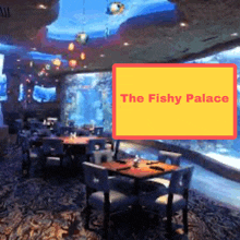 a restaurant called the fishy palace has a large fish tank in the background