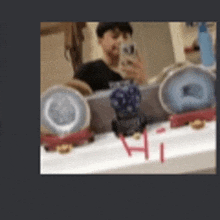 a man is taking a selfie in front of a bathroom mirror .