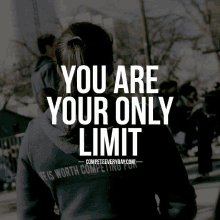 a woman wearing a black hoodie with the words you are your only limit on it