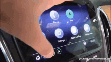 a person 's hand is pressing a button on a screen that says settings