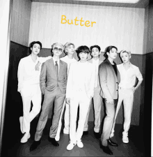 a black and white photo of a group of men with the word butter on the bottom right