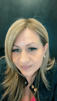 a close up of a woman 's face with a black background