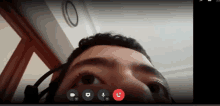 a man wearing a headset is on a video call with a red button that says call