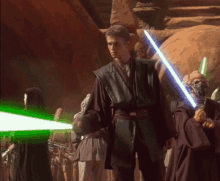 a man holding a light saber stands in front of a group of people