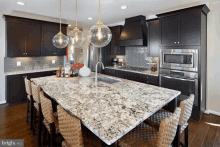 a kitchen with stainless steel appliances and a large granite counter top