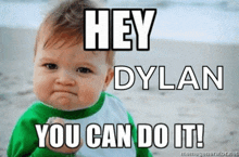 a baby with a fist in the air with the words hey dylan you can do it