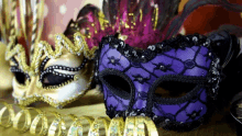 a purple mask is sitting next to a gold ribbon