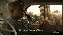 a man in a car with the words kiss me major glenn on the bottom