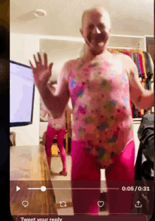 a video of a man in pink tights is being played on a cell phone