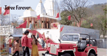 a red jeep is parked in front of a white building with the words " toree forever " written above it