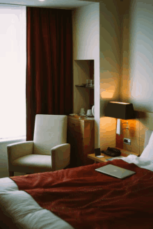 a hotel room with a laptop on the bed